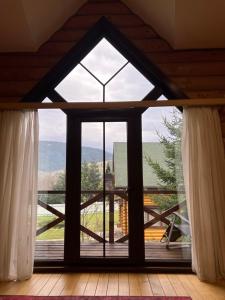 a large window in a room with a view at Guest House in Synevyrsʼka Polyana
