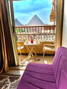 balcone con tavolo e vista sulle piramidi di Ramses Pyramids View Apartment a Il Cairo