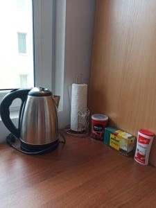 a tea kettle on a wooden counter with a roll of paper towels at Gabrovo Relax Apartment in Gabrovo