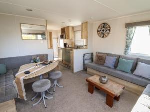 a living room with a table and a couch at HD Retreat in Lincoln