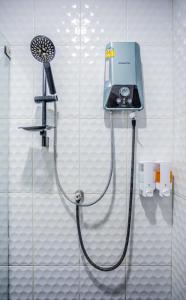 a shower in a bathroom with a shower head at Villa loved beach AO Nam Mao krabi in Ao Nam Mao