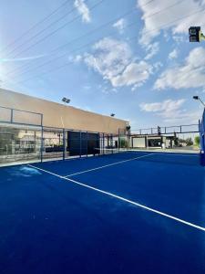 a tennis court in front of a building at Rohara Resort in Taif