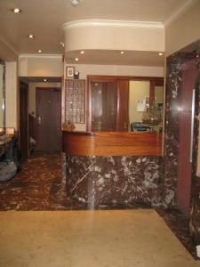 a lobby with a marble counter in a building at Hotel du Roy in Bouillon