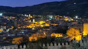 a view of a city at night at Esc 9 in Fez