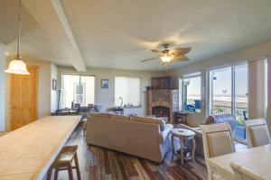 a living room with a couch and a table at Quiet Waterfront Escape with Hot Tub and Beach Access! in Gold Beach