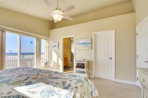 a bedroom with a bed with a view of the ocean at Quiet Waterfront Escape with Hot Tub and Beach Access! in Gold Beach