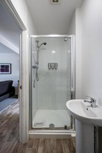 a bathroom with a shower and a sink at Neath road -Flat 3 in Swansea