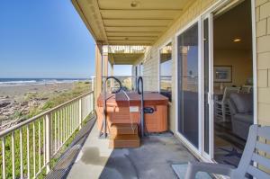 a balcony with a sink and a view of the beach at Quiet Waterfront Escape with Hot Tub and Beach Access! in Gold Beach