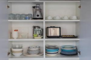 a pantry with plates and dishes and a blender at Villa loved beach AO Nam Mao krabi in Ao Nam Mao