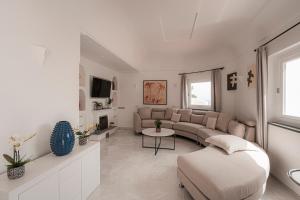 a living room with a couch and a table at Villa Magia in Positano