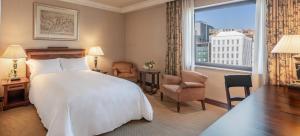 a hotel room with a bed and a large window at InterContinental Madrid, an IHG Hotel in Madrid