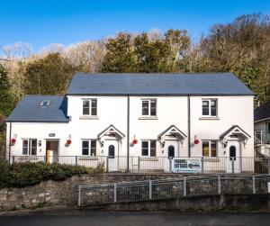 a white house with a black roof at Rhossili Holiday Cottage - 2 Bedroom - Parkmill in Parkmill