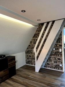 a staircase in a room with a brick wall at Ferienhaus Marianne im Harz in Langelsheim