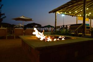a fire pit in a patio at night at Playa Paraíso in Playas