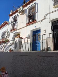 a building with a blue door and a fence at Ascent At Alora in Málaga +18 photos