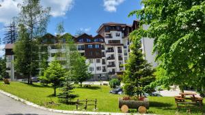 a large apartment building on a hill with a park at Borovets Dream Studio in Borovets