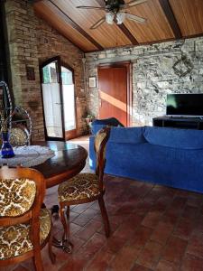 a living room with a blue couch and a table at Antica Riserva in Castiglione del Lago