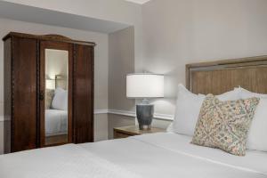 a bedroom with a bed and a mirror at Hamilton Turner Inn in Savannah