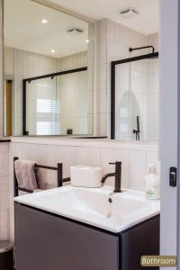 a bathroom with a sink and a mirror at Station Cottage in North Berwick