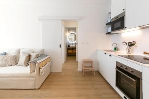 Una sala de estar con un sofá y una cocina. en Estrelas da Praia, en Consolacao 8 fotos más
