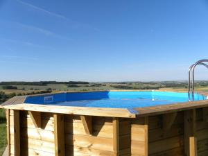 una terraza de madera con piscina en la parte superior de una casa en Moulin de Salles en Mas-dʼAuvignon