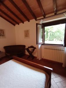 a bedroom with a bed and a window at Antica Riserva in Castiglione del Lago