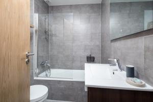 a bathroom with a toilet and a sink and a shower at BeGuest Bright Inn Lisbon Apartment in Lisbon