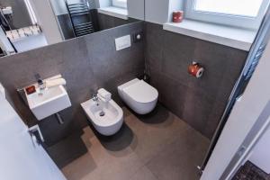 a small bathroom with a toilet and a sink at Wellness Hotel Casa Barca (Adult Only) in Malcesine