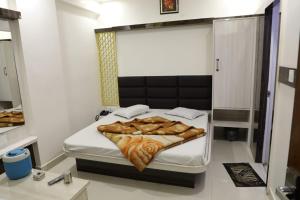 a small bedroom with a bed with blankets on it at Hotel Sahil 4 Min Distance from Dargah in Ajmer