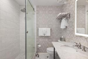 a bathroom with a shower and a sink and a toilet at Hamilton Turner Inn in Savannah