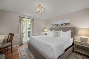 a bedroom with a bed and a desk and a chair at Hamilton Turner Inn in Savannah
