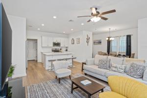 a living room with a couch and a table at Chic Townhouse by LSU in Baton Rouge