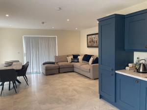 a living room with a couch and a table at 15 Waterwheel Wharf, Annalong in Newry