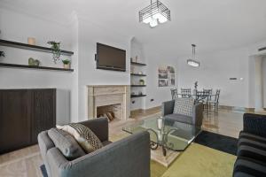 a living room with two chairs and a fireplace at Sierra Blanca in Marbella