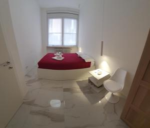 a white room with a bed and a window at Appartamenti Reali Bonaccini in Milan