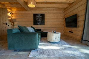 a living room with a couch and a table at Chalet NON-SENS by L'Occitane in Hochrindl