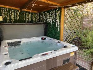 a jacuzzi tub in the backyard of a house at Luxury lodge, foot of South Downs nr beach in Ferring