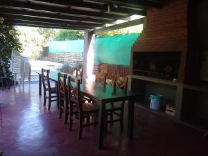 ein Esszimmer mit einem Tisch, Stühlen und einem Kamin in der Unterkunft Casaquinta La Maju En La Reja! in La Reja