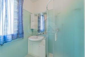 a bathroom with a sink and a mirror and a shower at L'Albero del Pepe 1 - Goelba in Campo nell'Elba