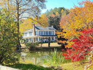 a large house with a pond in front of it at Historic Seaton Springs Farm B&B - J Seaton King Room & Private Bath in Sevierville