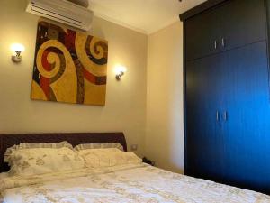 a bedroom with a bed and a blue closet at Porto marina for rent in El Alamein