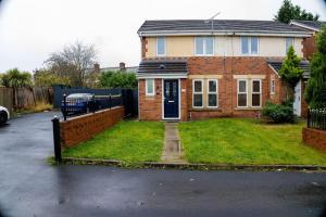 a brick house with a gate and a driveway at Dynasty Lodge Manchester - Alison Kelly close in Manchester