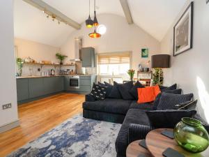 a living room with a couch and a kitchen at The Arms House in Telford