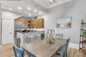 a kitchen and dining room with a wooden table and chairs at Le Jardin 168 - 3BR 3.5BA - (10) in Destin