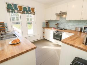 a kitchen with a plate of food on a counter at 5 The Nab House in Bembridge