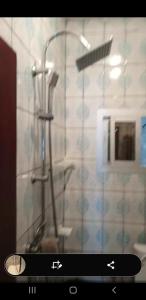 a bathroom with a shower with a sink and a shower at Superbe appartement in Douala