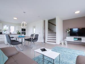 a living room with a couch and a table at Ferienhaus JONA in Burhave