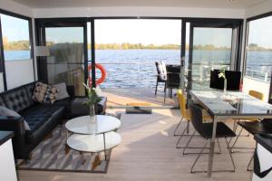 a living room with a couch and a table on a boat at Floating 44 in Xanten - Boot 5 in Xanten