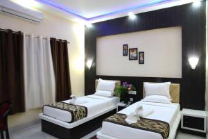 two beds in a hotel room with at HOTEL MARIYA INTERNATIONAL in Bodh Gaya