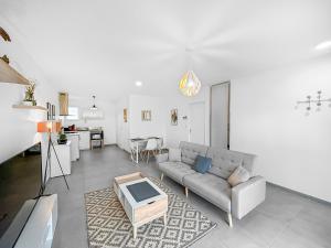 a living room with a couch and a table at L'Eclat de la Gironde in La Hourcade